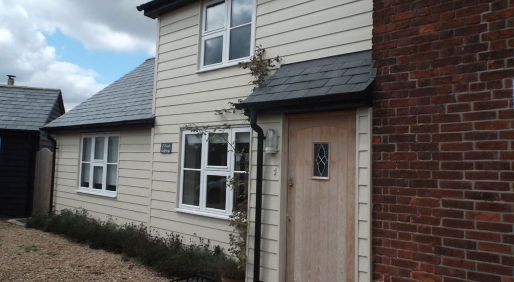 Two storey and single storey extension finished in weatherboarding