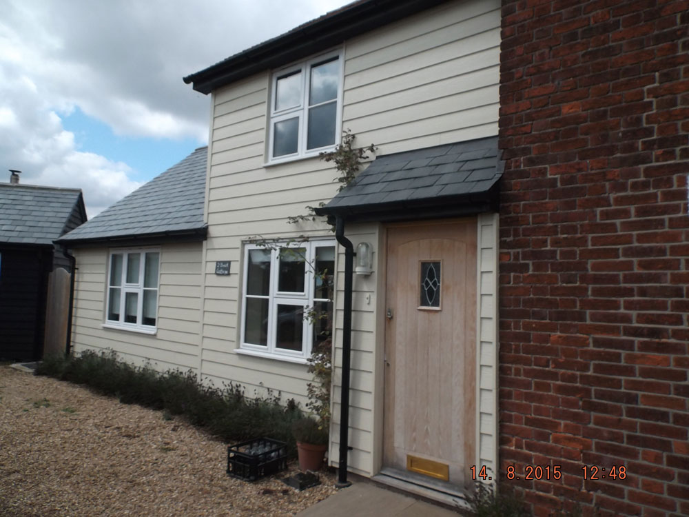 Two storey and single storey extension finished in weatherboarding