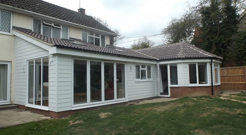 Rear single storey extension finished with weatherboarding and pan tiled roof.