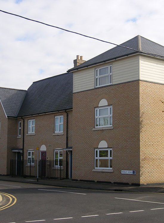 Three storey element accommodating offices with a mix of apartments and housing either side.