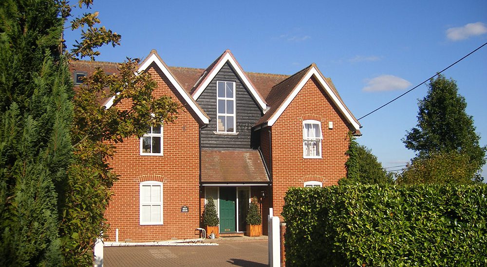 Front of the property with the new gable extension finished in black weatherboarding