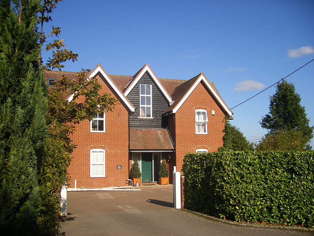 Front of the property with the new gable extension finished in black weatherboarding