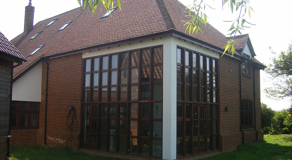 Two storey high timber windows to living room