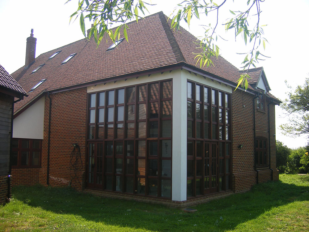 Two storey high timber windows to living room